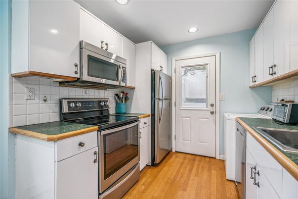 Interior, Kitchen, Recessed Lighting, Stainless Steel Appliances, Tile Countertops, Wood Texture Flooring
