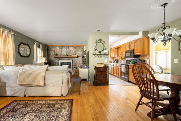 Chandelier, Dining room, Fireplace, Interior, Kitchen, Living room, Pendant Lights, Stone Walls, Wood Texture Flooring