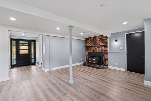 Empty room, Fireplace, Interior, Recessed Lighting, Stone Walls, Wood Texture Flooring