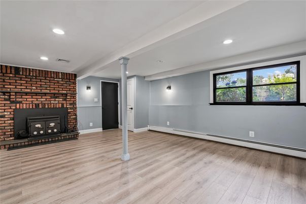 Empty room, Fireplace, Interior, Recessed Lighting, Stone Walls, Wood Texture Flooring