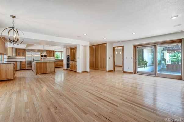 Chandelier, Empty room, Interior, Kitchen, Recessed Lighting, Stainless Steel Appliances, Wood Texture Flooring