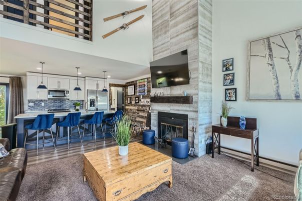Fireplace, Interior, Kitchen, Pendant Lights, Recessed Lighting, Stainless Steel Appliances, Stone Walls, Wood Texture Flooring