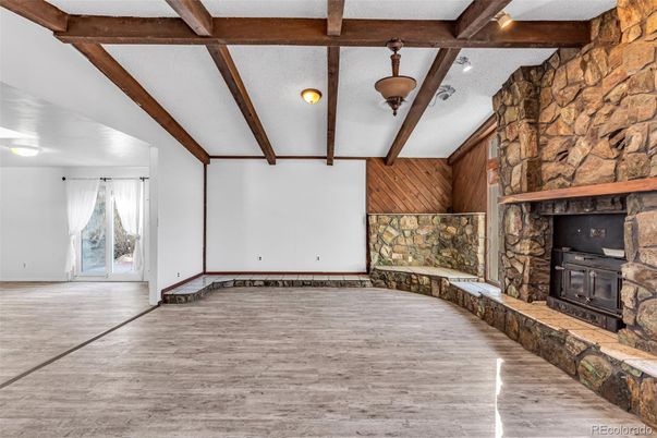 Empty room, Fireplace, Interior, Stone Walls, Wooden Beams, Wood Texture Flooring