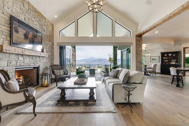 Chandelier, Dining room, Fireplace, Interior, Living room, Recessed Lighting, Stone Walls, Wooden Beams, Wood Texture Flooring