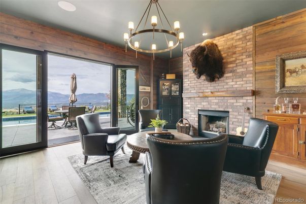 Chandelier, Fireplace, Interior, Living room, Pendant Lights, Recessed Lighting, Stone Walls, Wood Texture Flooring, Wooden Walls