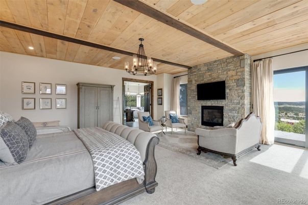 Bedroom, Chandelier, Fireplace, Interior, Living room, Recessed Lighting, Stone Walls, Wooden Beams, Wooden Ceilings