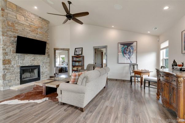 Fireplace, Interior, Living room, Recessed Lighting, Stone Walls, Wood Texture Flooring
