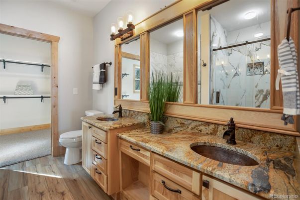 Bathroom, Dual Sink Vanities, Glass Shower, Interior, Marble Walls, Wood Texture Flooring