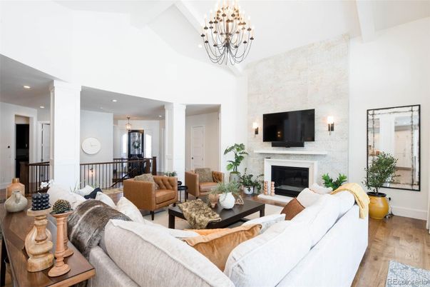 Chandelier, Fireplace, Interior, Living room, Recessed Lighting, Stone Walls, Wood Texture Flooring