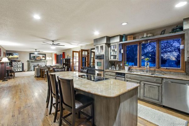 Dining room, Fireplace, Interior, Kitchen, Living room, Recessed Lighting, Stainless Steel Appliances, Wood Texture Flooring