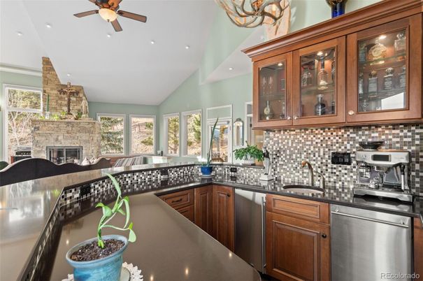 Fireplace, Interior, Kitchen, Recessed Lighting, Stainless Steel Appliances, Stone Walls
