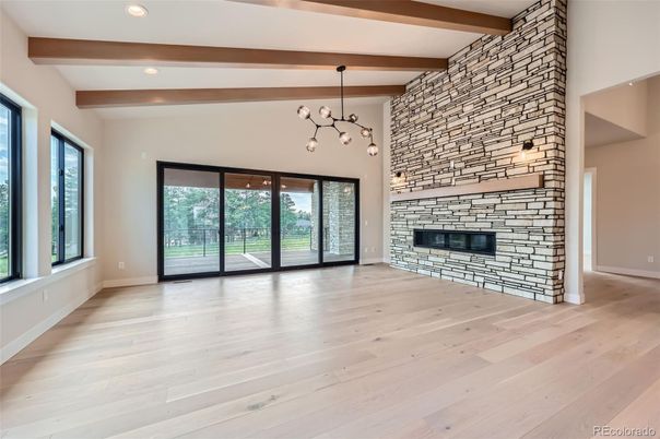 Empty room, Fireplace, Interior, Pendant Lights, Recessed Lighting, Stone Walls, Wooden Beams, Wood Texture Flooring