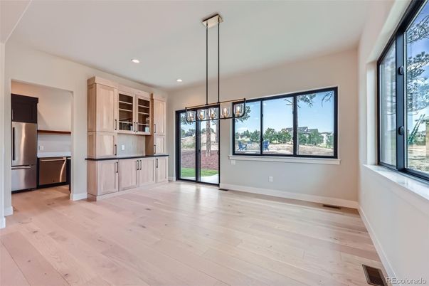 Empty room, Interior, Kitchen, Pendant Lights, Recessed Lighting, Stainless Steel Appliances, Wood Texture Flooring