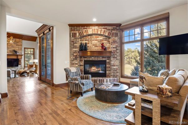 Dining room, Fireplace, Interior, Living room, Recessed Lighting, Stone Walls, Wood Texture Flooring