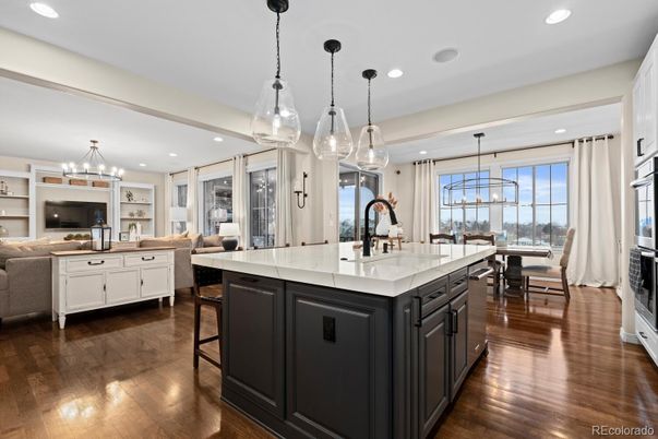 Chandelier, Dining room, Interior, Kitchen, Living room, Pendant Lights, Recessed Lighting, Stainless Steel Appliances, Wood Texture Flooring