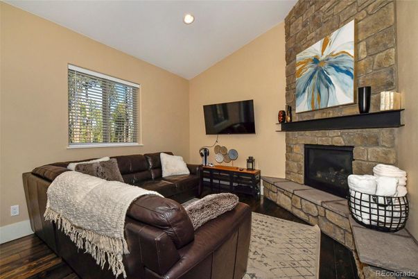 Fireplace, Interior, Living room, Recessed Lighting, Stone Walls, Wood Texture Flooring