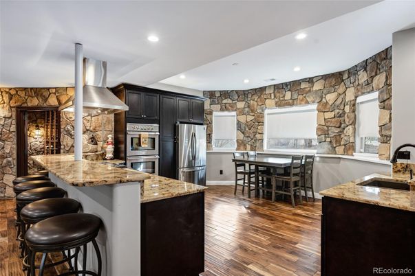 Dining room, Interior, Kitchen, Recessed Lighting, Stainless Steel Appliances, Stone Walls, Wood Texture Flooring