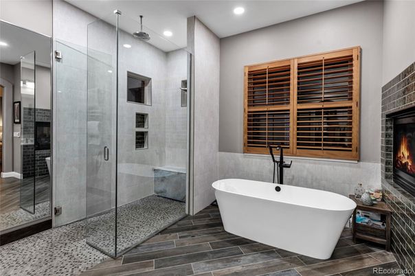 Bathroom, Fireplace, Free Standing Baths, Glass Shower, Interior, Recessed Lighting, Wood Texture Flooring