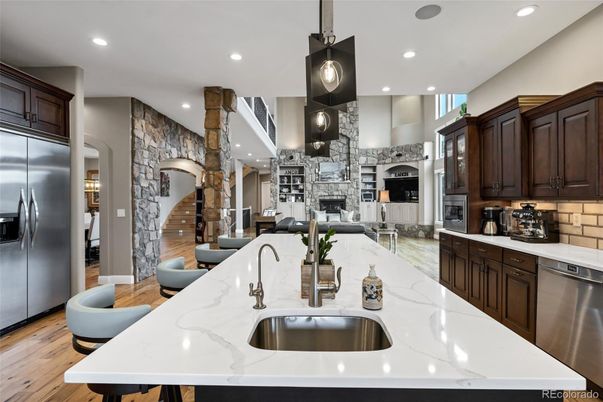 Fireplace, Interior, Kitchen, Pendant Lights, Recessed Lighting, Stainless Steel Appliances, Stone Walls, Wood Texture Flooring