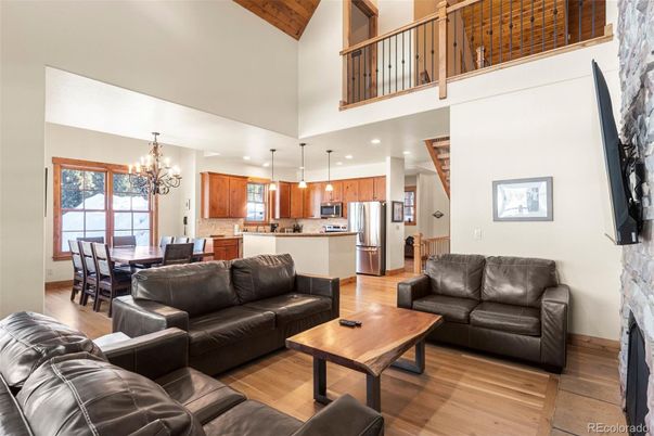 Chandelier, Dining room, Interior, Kitchen, Living room, Pendant Lights, Recessed Lighting, Stainless Steel Appliances, Wood Texture Flooring