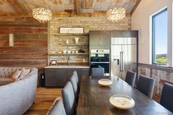 Chandelier, Dining room, Interior, Kitchen, Pendant Lights, Stainless Steel Appliances, Stone Walls, Wooden Ceilings, Wood Texture Flooring