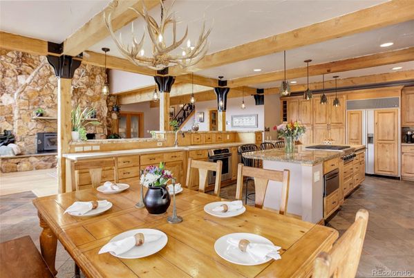 Chandelier, Dining room, Fireplace, Interior, Kitchen, Pendant Lights, Recessed Lighting, Stainless Steel Appliances, Stone Walls, Wooden Beams