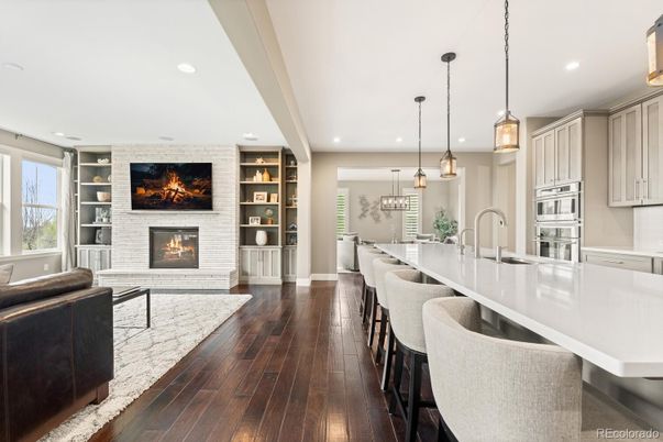 Fireplace, Interior, Kitchen, Pendant Lights, Recessed Lighting, Stainless Steel Appliances, Stone Walls, Wood Texture Flooring