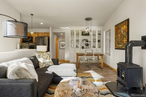 Fireplace, Interior, Kitchen, Living room, Pendant Lights, Recessed Lighting, Stainless Steel Appliances, Wood Texture Flooring