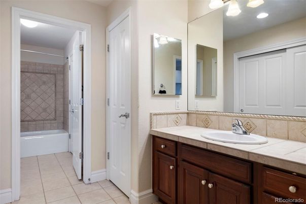 Bathroom, Dual Sink Vanities, Glass Shower, Interior, Recessed Lighting, Tile Countertops