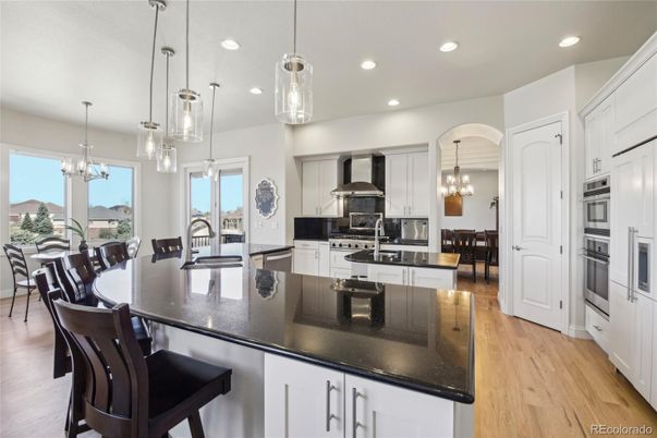 Chandelier, Dining room, Interior, Kitchen, Pendant Lights, Recessed Lighting, Stainless Steel Appliances, Wood Texture Flooring