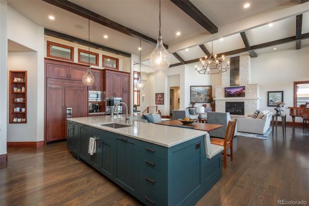 Chandelier, Dining room, Fireplace, Interior, Kitchen, Living room, Pendant Lights, Recessed Lighting, Stainless Steel Appliances, Stone Walls, Wooden Beams, Wood Texture Flooring