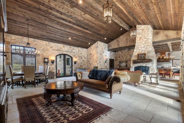Chandelier, Dining room, Fireplace, Interior, Living room, Pendant Lights, Recessed Lighting, Stone Walls, Wooden Beams, Wooden Ceilings