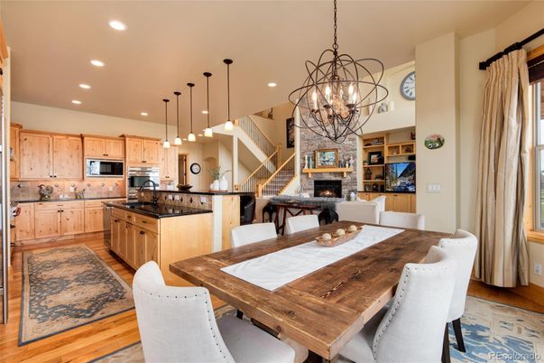Chandelier, Dining room, Fireplace, Interior, Kitchen, Pendant Lights, Recessed Lighting, Stainless Steel Appliances, Wood Texture Flooring