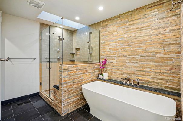 Bathroom, Free Standing Baths, Glass Shower, Interior, Recessed Lighting, Stone Walls
