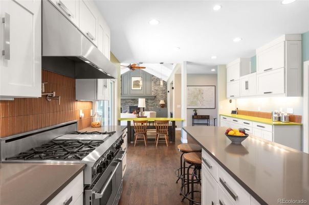 Dining room, Fireplace, Interior, Kitchen, Pendant Lights, Recessed Lighting, Stainless Steel Appliances, Stone Walls, Wood Texture Flooring