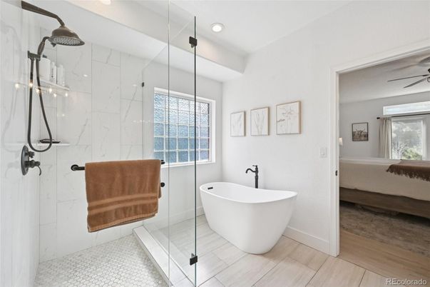 Bathroom, Free Standing Baths, Glass Shower, Interior, Marble Walls, Recessed Lighting, Wood Texture Flooring