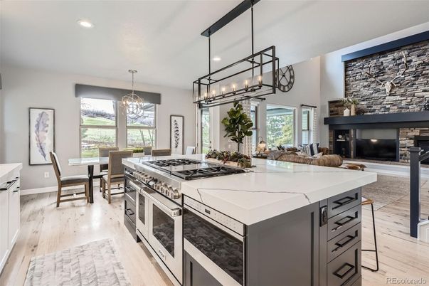 Chandelier, Dining room, Fireplace, Interior, Kitchen, Living room, Pendant Lights, Recessed Lighting, Stainless Steel Appliances, Wood Texture Flooring