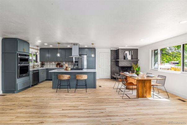 Dining room, Fireplace, Interior, Kitchen, Pendant Lights, Recessed Lighting, Stainless Steel Appliances, Stone Walls, Wood Texture Flooring
