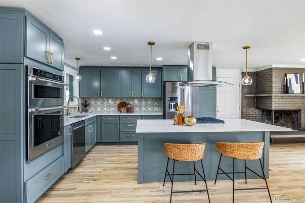 Fireplace, Interior, Kitchen, Pendant Lights, Recessed Lighting, Stainless Steel Appliances, Stone Walls, Wood Texture Flooring