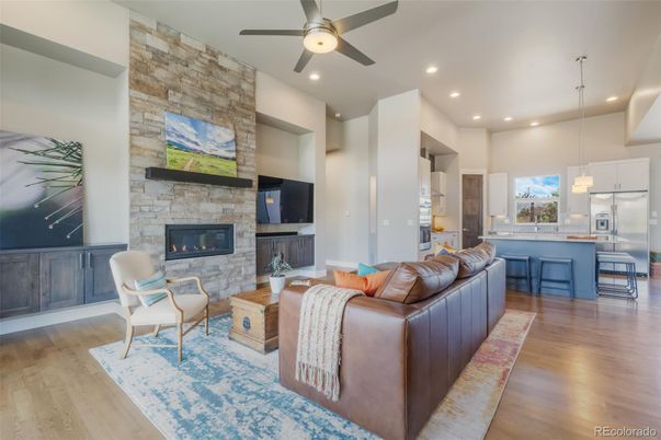 Fireplace, Interior, Kitchen, Living room, Pendant Lights, Recessed Lighting, Stainless Steel Appliances, Stone Walls, Wood Texture Flooring