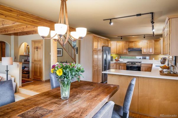 Chandelier, Dining room, Interior, Kitchen, Stainless Steel Appliances, Wood Texture Flooring