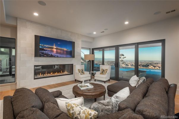 Fireplace, Interior, Living room, Recessed Lighting, Stone Walls, Water, Wood Texture Flooring