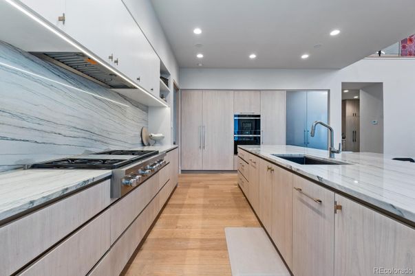 Interior, Kitchen, Marble Walls, Recessed Lighting, Stainless Steel Appliances, Wood Texture Flooring