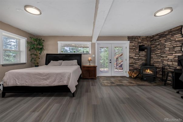 Bedroom, Fireplace, Interior, Recessed Lighting, Stone Walls, Wood Texture Flooring