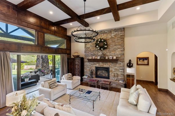 Chandelier, Fireplace, Interior, Living room, Recessed Lighting, Stone Walls, Wooden Beams, Wood Texture Flooring
