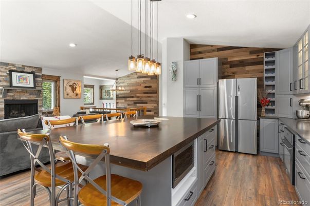 Dining room, Fireplace, Interior, Kitchen, Pendant Lights, Recessed Lighting, Stainless Steel Appliances, Wood Texture Flooring, Wooden Walls
