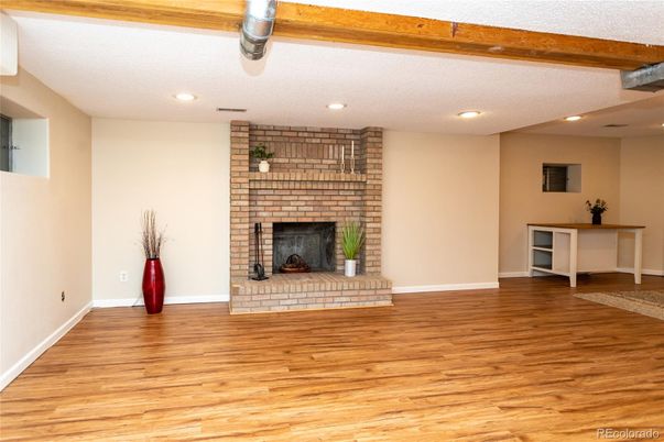 Empty room, Fireplace, Interior, Recessed Lighting, Stone Walls, Wooden Beams, Wood Texture Flooring