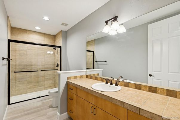Bathroom, Glass Shower, Interior, Recessed Lighting, Tile Countertops, Wood Texture Flooring