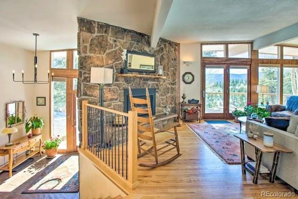 Chandelier, Fireplace, Interior, Living room, Pendant Lights, Stone Walls, Wood Texture Flooring