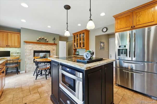 Fireplace, Interior, Kitchen, Pendant Lights, Recessed Lighting, Stainless Steel Appliances, Stone Walls